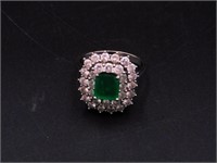 18kt white gold diamond and emerald lady's ring.