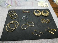 9 pairs of gold earrings marked 14K weighing