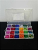 divided Rubbermaid box with plastic beads and