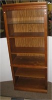 Lighted Thomasville six shelf wood cabinet.