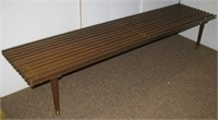 Slat style wood bench with pencil legs. Measures