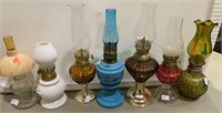 7 miniature glass oil lamps - all with glass