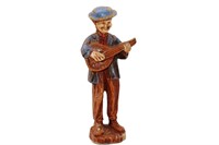 A Vintage Instrument Playing Man Figure