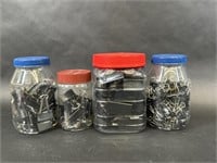 Four Jars Full of Varying Sized Binder Clips