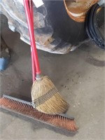 Push broom and straw broom, content in background