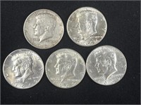 Three 1969 with two 1964 Kennedy half dollars