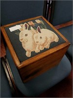 wooden box upholstered with rabbits