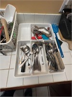 Lots of kitchen utensils and flatware