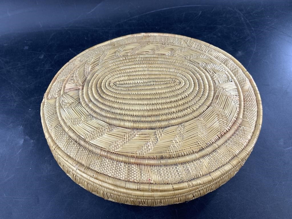 Beautiful woven grass basket with lid with some co