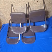 4 Brown metal folding chairs.