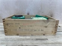 Wooden handled box with empty die and ammo cases