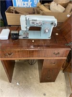 Sewing machine and cabinet with foot pedal and a