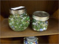 Two Mason jars of unsorted marbles