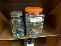 Two large jars of unsorted marbles incl shooters