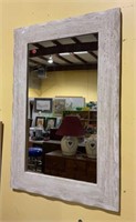 Modern style wall mirror with a heavy composite