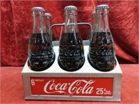 Aluminum Coca cola 6 pack w/ full bottles.