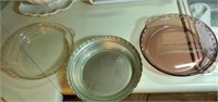 3 glass pie pans and an aluminum pan