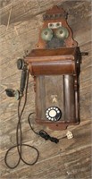 Ornate oak cased cabinet wall phone with twin