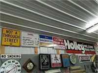 4 vintage metal signs and a banner