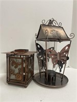 Decorative tea candle lantern and a bird feeder.