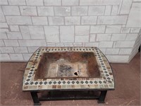 Outdoor wood fireplate with tile edging