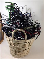Woven basket full of plastic hangers