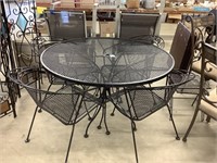 4 foot round metal table with four chairs and two