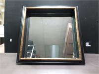 Shadow box style framed mirror.