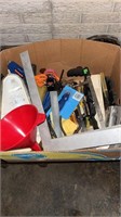 Box of assorted tools, including hacksaw, hammer,