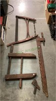 Two antique wooden clamps and an antique saw - all