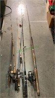 Large collection of fishing rods - some with reels