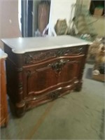 Marble top carved front cabinet
