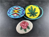 Three intricately beaded belt buckles in Native Am