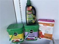Partial containers of plant food, fertilizer,