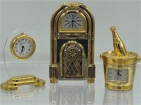 3 Miniature brass clocks, jukebox, champagne and