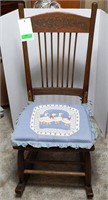 Carved floral rocking chair with duck cushion