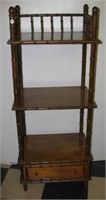 Three tier wood stand with single drawer.