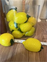 Large glass container with glass lemons.