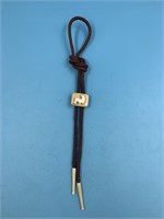 Bolo tie with fossilized ivory centerpiece and a w