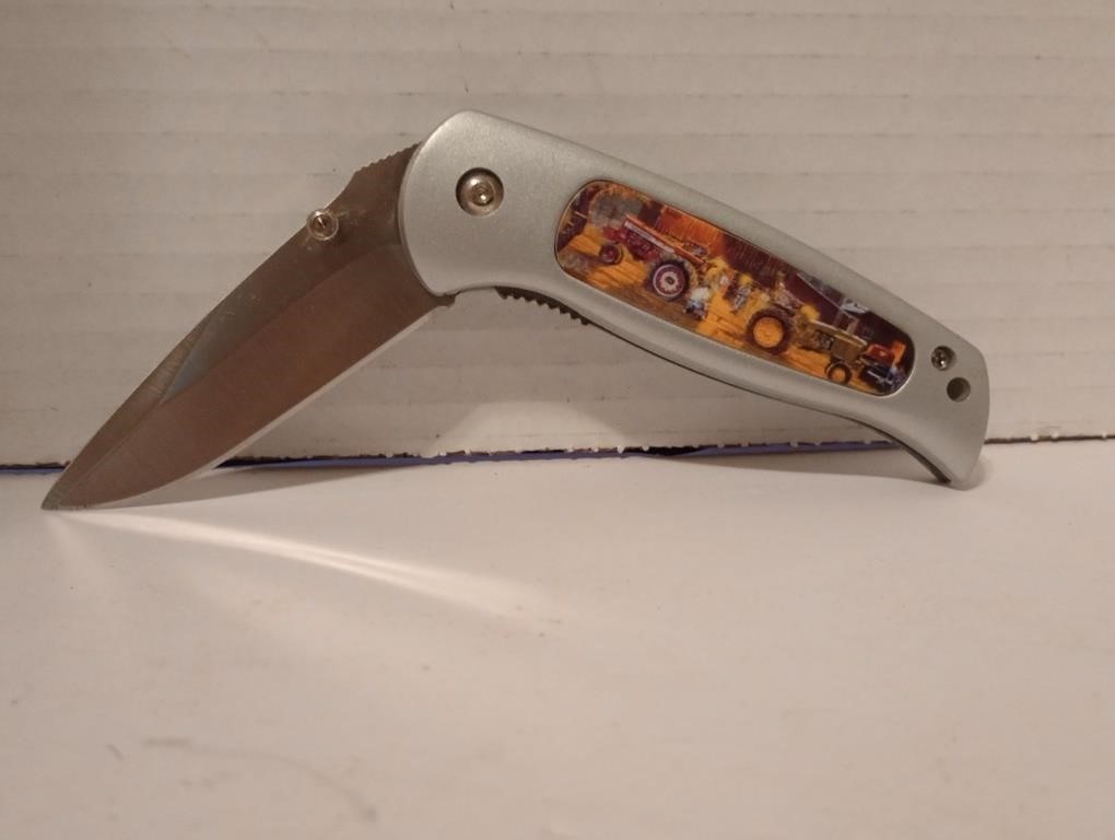 Great stainless pocket knife with tractor scene on