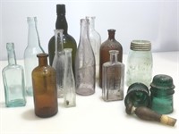 Assorted antique and vintage bottles and jars.