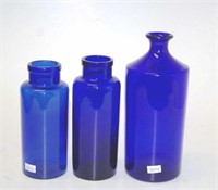 Three blue glass bottles