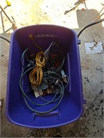 Plastic tote full of extension cords, misc elect
