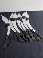 Eight plastic swords and eye patches