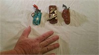 Three miniature guns and holsters