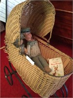 Antique wicker doll carriage with vintage dolls