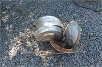 WIRE BASKET FULL OF OLD HUBCAPS