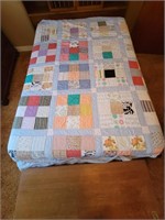 Full size blue quilt with stitched squares