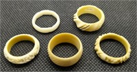 Five antique bone or bakelite rings