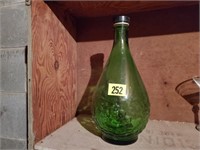 Tall green glass bottle